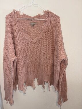 Pink long sleeve sweater with distressed hem